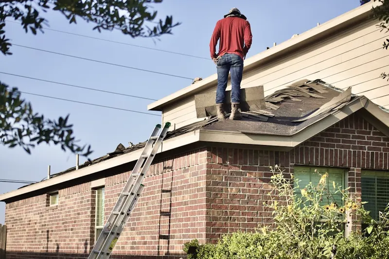 Professional roofer working on a residential roof in Stanwick